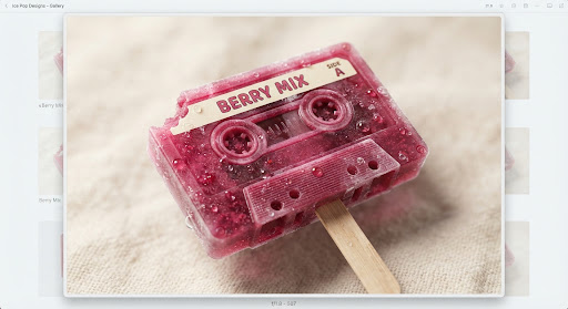 A translucent berry ice pop shaped like a vintage cassette tape.